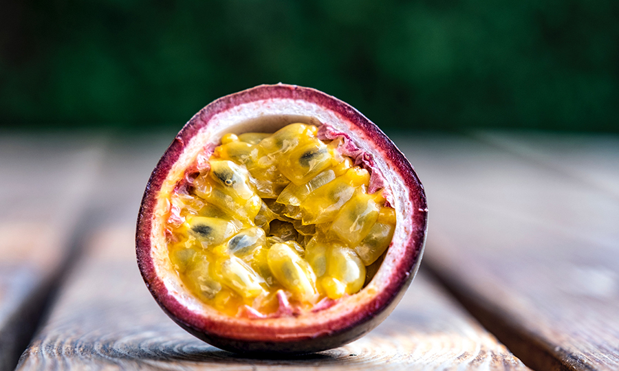 sliced open passion fruit with flesh and seeds exposed