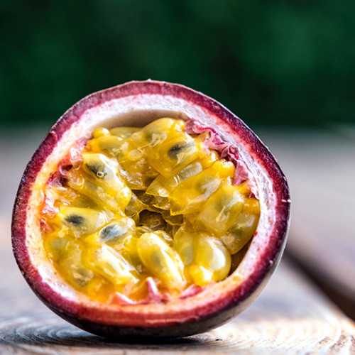 sliced open passion fruit with flesh and seeds exposed