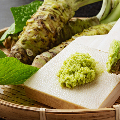 bamboo tray with wasabi roots and spoonful of wasabi paste on tray