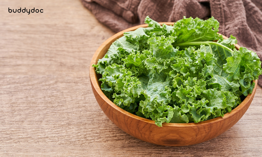 small wooden bowl of kale on wooden table