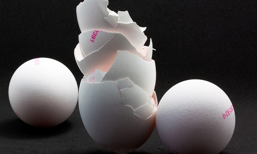 Several cracked egg shells stacked on top of each other