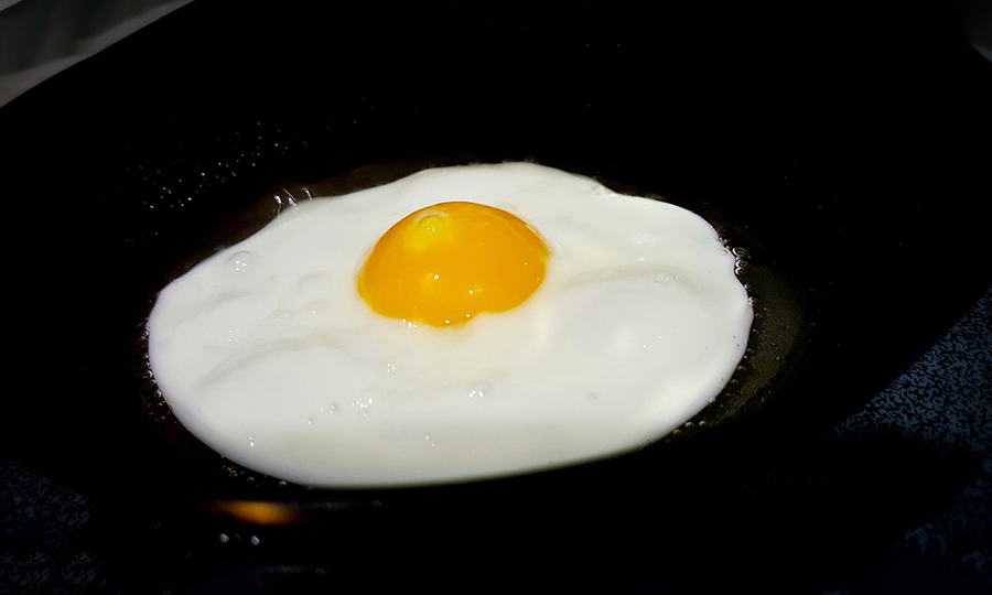 an egg being cooked sunny side up
