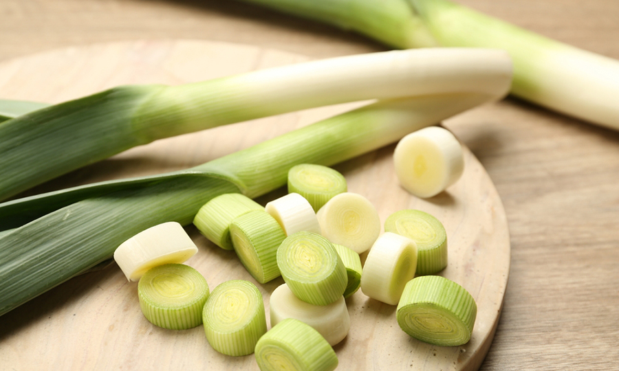 leek cut into bite sized pieces on a wooden tray