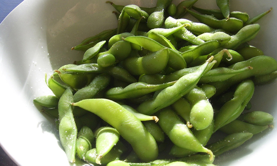 metal bowl full of soybean pods