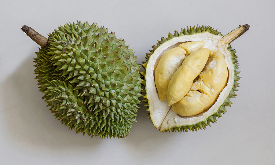 A wooden tray with a pile of durian flesh laid on top